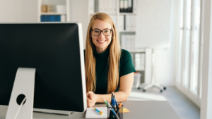 Girl sitting at desk with computer screen