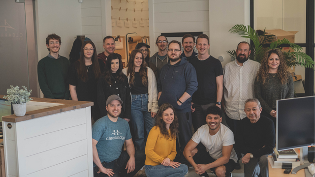 hiring an external IT company - Picture of a large team standing together in an office